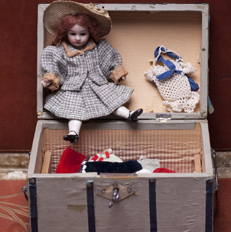Antique Mignonette doll with her wardrobe