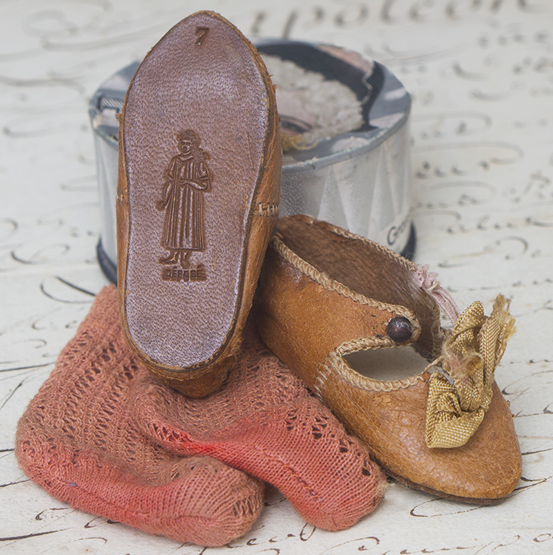 leather shoes with figure of doll